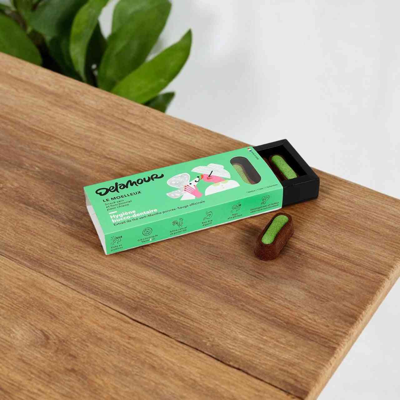 Moelleux Hygiène Dentaire Chien Delamour à la menthe poivrée et sauge, présenté dans une boîte verte avec stick semi-fondant visible. Idéal pour la santé bucco-dentaire des chiens.